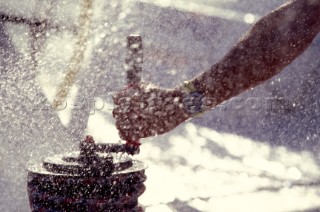 Detail of hand grinding winch in dramatic spray