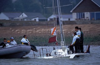 Crew on sinking yacht are rescued by race officials in a RIB