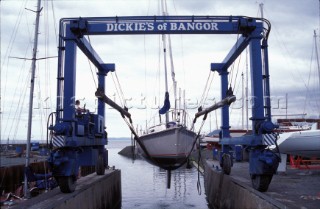 Travel lift taking yacht out of the water, Cowes Yacht Haven, Isle of Wight