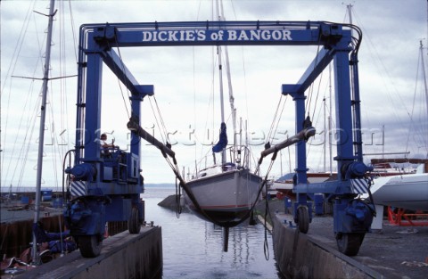 Travel lift taking yacht out of the water Cowes Yacht Haven Isle of Wight