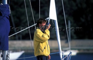 Man looking through a hand held compass