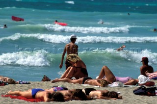 Sunbathers on a sandy beach