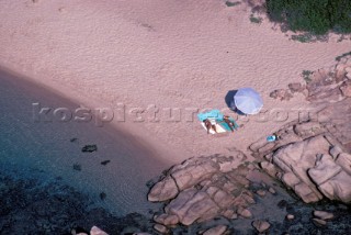 Couple sunbathing on the beach