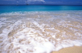 Sea washing on secluded tropical sandy beach