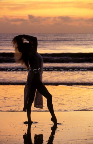 Model Jilly Johnson alone on a sandy beach in the sunset in Australia 