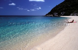 Girl sunbathing on sandy beach