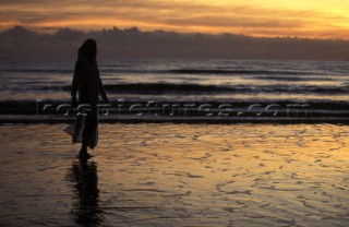 Woman on beach at sunset