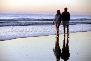 Couple taking a stroll on a sandy beach