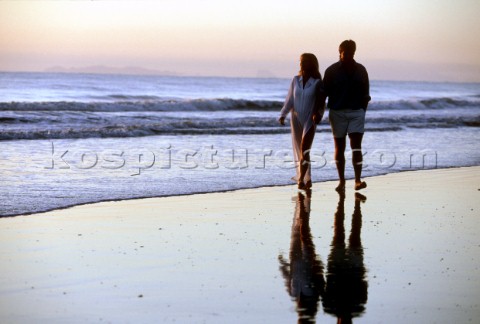 Couple taking a stroll on a sandy beach 