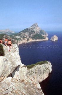 People take in a stunning view from a Mediterranean cliff top