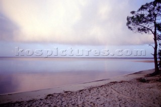 View from shore of rainbow over the lake at Lacanau, France