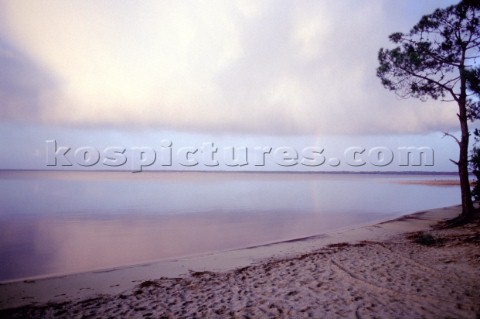 View from shore of rainbow over the lake at Lacanau France