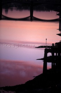 Reflection of Wandsworth Bridge at sunset in the river Thames, London