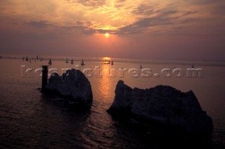 Yacht racing at sunset off the Needles, Isle of Wight, UK