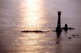 Sun reflected on the sea at Eddystone lighthouse off the coast of Plymouth, Devon, UK