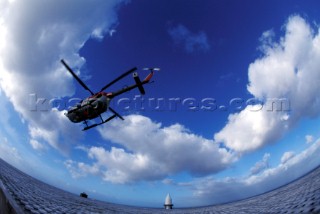 Helicopter flying over Eddystone lighthouse near Plymouth, UK