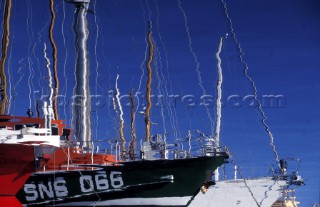 Refelction of moored boats in marina