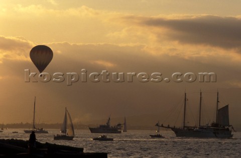 Hot air balloon flying over the harbour of Saint Tropez France at sunset