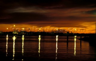 Masthead lights of commercial fishing boats reflected in the water