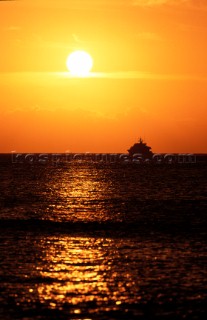 Superyacht on horizon at sunset
