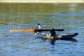 A skuller and his trainer on the river Thames, London