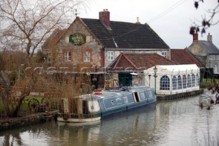 Canal boat moored outside public house (pub).  Canal boats on English Kennet and Avon Canals.