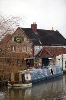 Canal boat moored outside public house (pub).  Canal boats on English Kennet and Avon Canals.