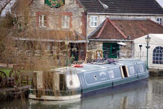 Canal boat moored outside public house (pub).  Canal boats on English Kennet and Avon Canals.