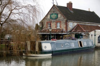 Canal boat moored outside public house (pub).  Canal boats on English Kennet and Avon Canals.