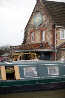 Canal boat moored outside public house (pub).  Canal boats on English Kennet and Avon Canals.