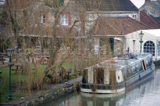 Canal boat moored outside public house (pub).  Canal boats on English Kennet and Avon Canals.