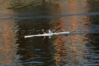 Two women in a Rowing scull on the River Thames.  Rowing pair.