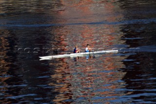 Two women in a Rowing scull on the River Thames.  Rowing pair.