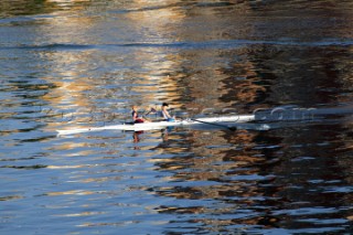 Two women in a Rowing scull on the River Thames.  Rowing pair.