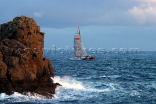 Maxi catamaran Orange skippered by Bruno Peyron crossing the startline of the Jules Verne