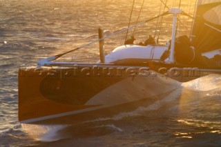 Maxi catamaran Orange skippered by Bruno Peyron crossing the startline of the Jules Verne