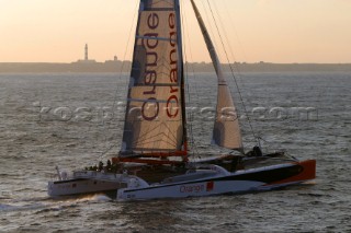 Maxi catamaran Orange skippered by Bruno Peyron crossing the startline of the Jules Verne