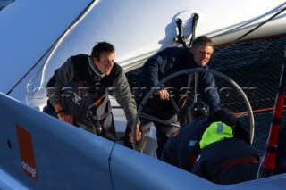 Maxi catamaran Orange skippered by Bruno Peyron crossing the startline of the Jules Verne