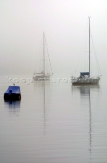 Yachts in the fog and mist on the River Dart in Devon