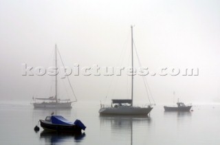 Yachts in the fog and mist on the River Dart in Devon