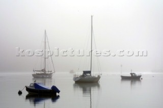 Yachts in the fog and mist on the River Dart in Devon