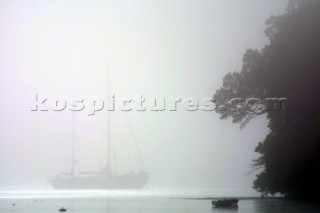 Yachts in the fog and mist on the River Dart in Devon