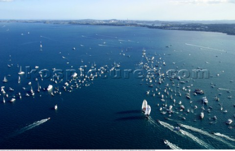 Switzerlands Alinghi Challenge leads Team New Zealands NZL82 to the finish line in front of a massiv