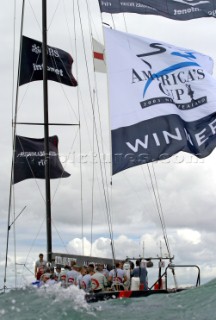 Switzerlands Alinghi Challenge carry the winner flag after defeating Team New Zealands NZL-82 during race five to win the Americas Cup in Auckland, New Zealand. Mar, 02. 2003.  Alinghi lead from the start to win by 0.45 seconds to make history being the first team to ever with the Louis Vuitton challenge series and the Americas Cup.