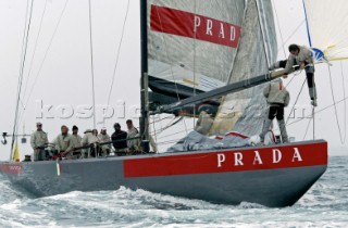 Italys Prada Challenge bowman Paolo Bassani right cliams down from the sits spinnaker pole as team mates watch on in perparation for testing after racing was called off on race day one of the Louis Vuitton Cup, Quarter final repechage.Auckland, New Zealand. Nov, 23. 2002  . (Photo credit: Sergio Dionisio/Kos Picture Source)