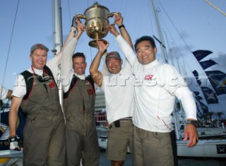 Crewman from Pizza-La Sailing Team (L-R) skipper Peter Gilmour, Mike Mottl, Kazuhiko Sofuku and Yasuhiro Yaji hold up the King Edward Cup after winning the mens final of the Investors Guaranty presentation of the King Edward VII Gold Cup 2003, Royal Bermuda Yacht Club, Hamilton, Bermuda. Oct, 26th. 2003