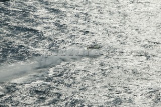 Lone powerboat crosses metalic sea