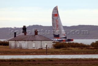 Round the Isle of Wight Race 2004 organised by the Island Sailing Club. Maxi cat Orange passing Hurst Castle attempting a new race record.