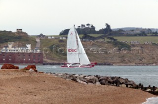 Round the Isle of Wight Race 2004 organised by the Island Sailing Club. Maxi trimaran IDEC passing Hurst Castle attempting a new race record.