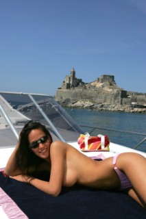 A glamorous model onboard a luxurious powerboat in the Mediterranean